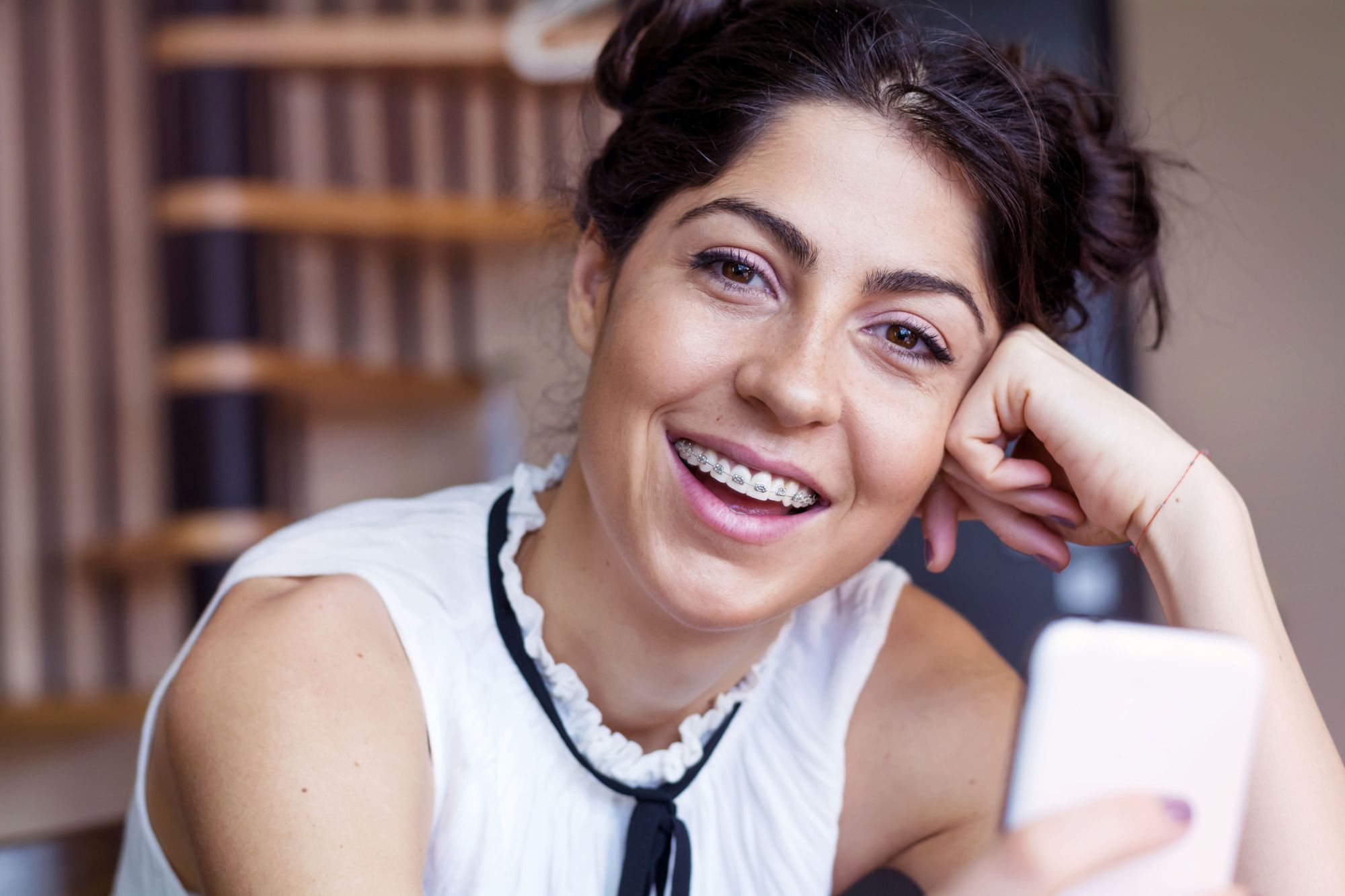 Adult woman smiling with braces